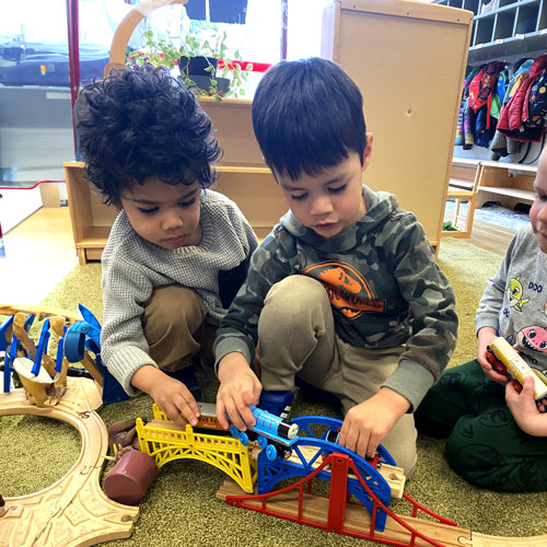 boys playing with train